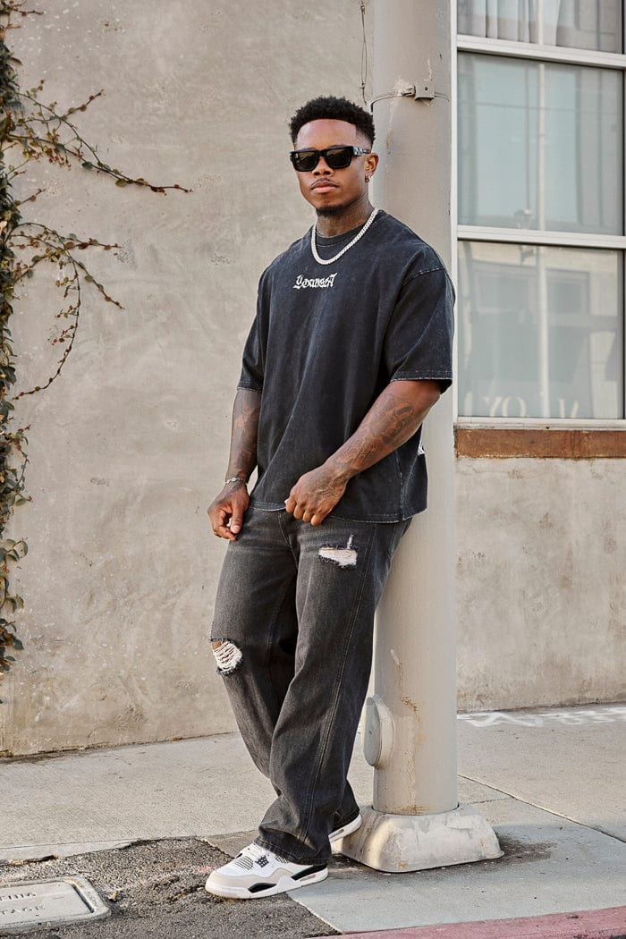 6025 - Straight Fit Ripped Jeans- Straight-leg jeans made from heavy 415 GSM cotton, structured yet softening over time, featuring minimal detailing for a vintage-inspired, timeless look in Black Wash.