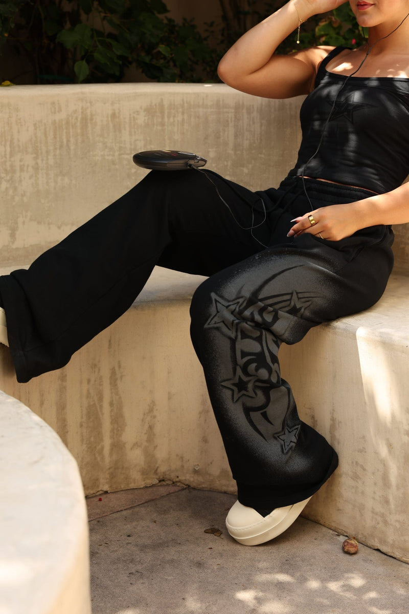 W281 Flashback Joggers- Lightweight, breathable 2000-inspired joggers with a bold airbrushed logo, oversized low-rise fit, and adjustable drawstrings for comfort and style in Black