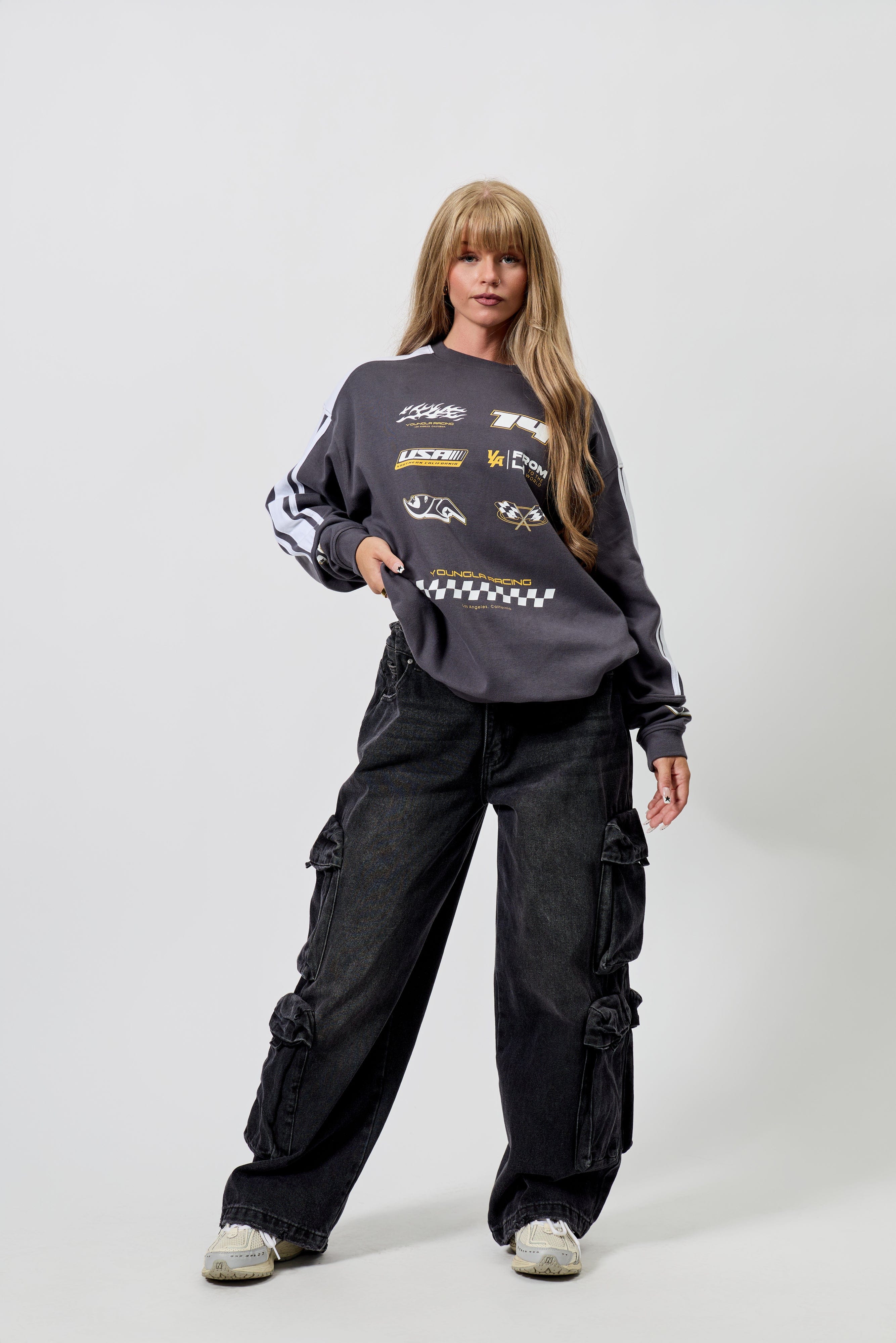 W231 - Drift Cargo Jeans - Oversized streetwear jeans with unique cargo pockets and hidden waistband adjusters for a customizable fit. Tall-friendly with an elongated inseam. Perfect with sneakers or heels for effortless style in Black Wash.