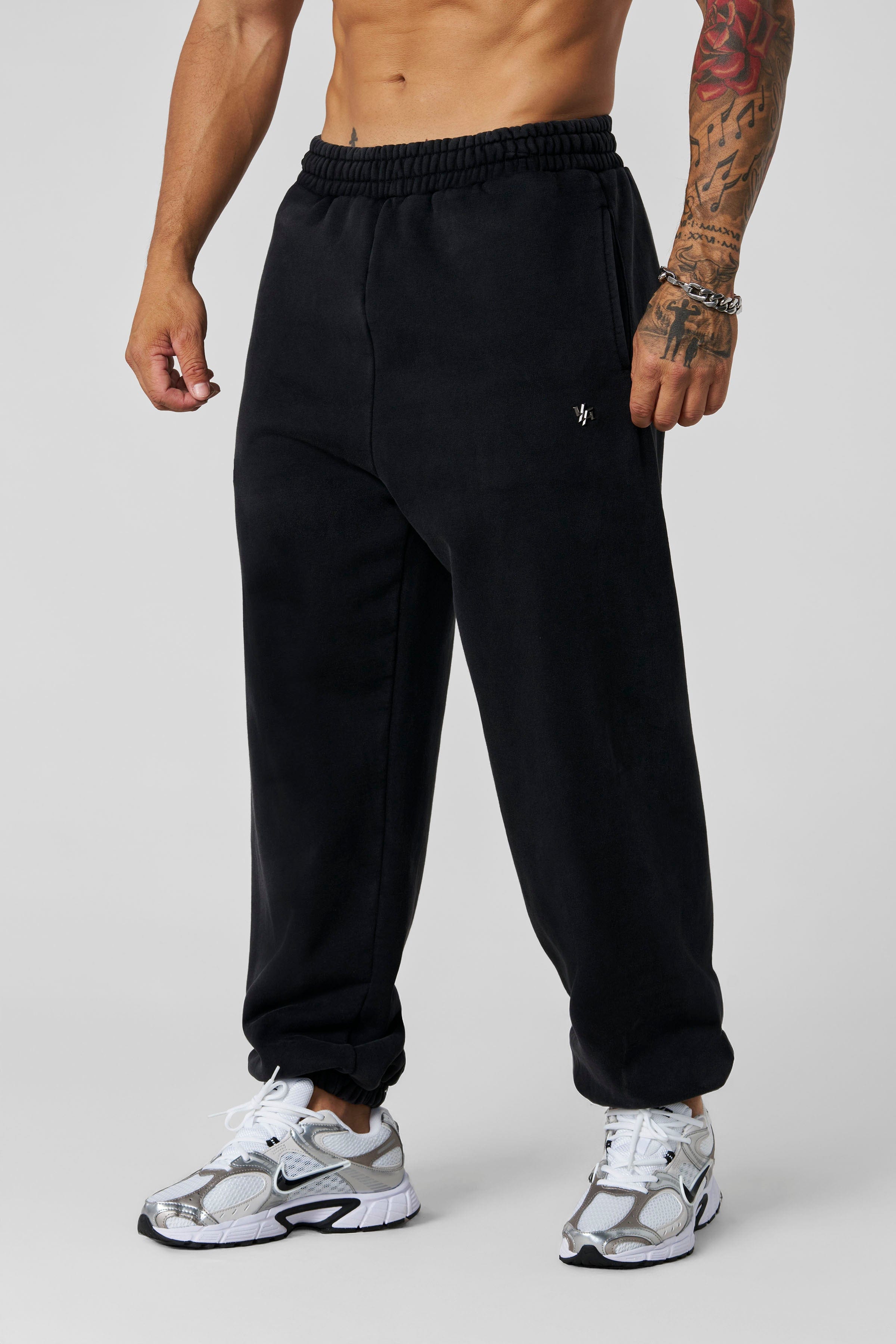 2069 - Elevated Essentials - Baggy Joggers — oversized, comfortable fit with cuffed ankles, structured heavyweight cotton, and subtle “Elevated” branding for a premium, versatile look in Black Wash