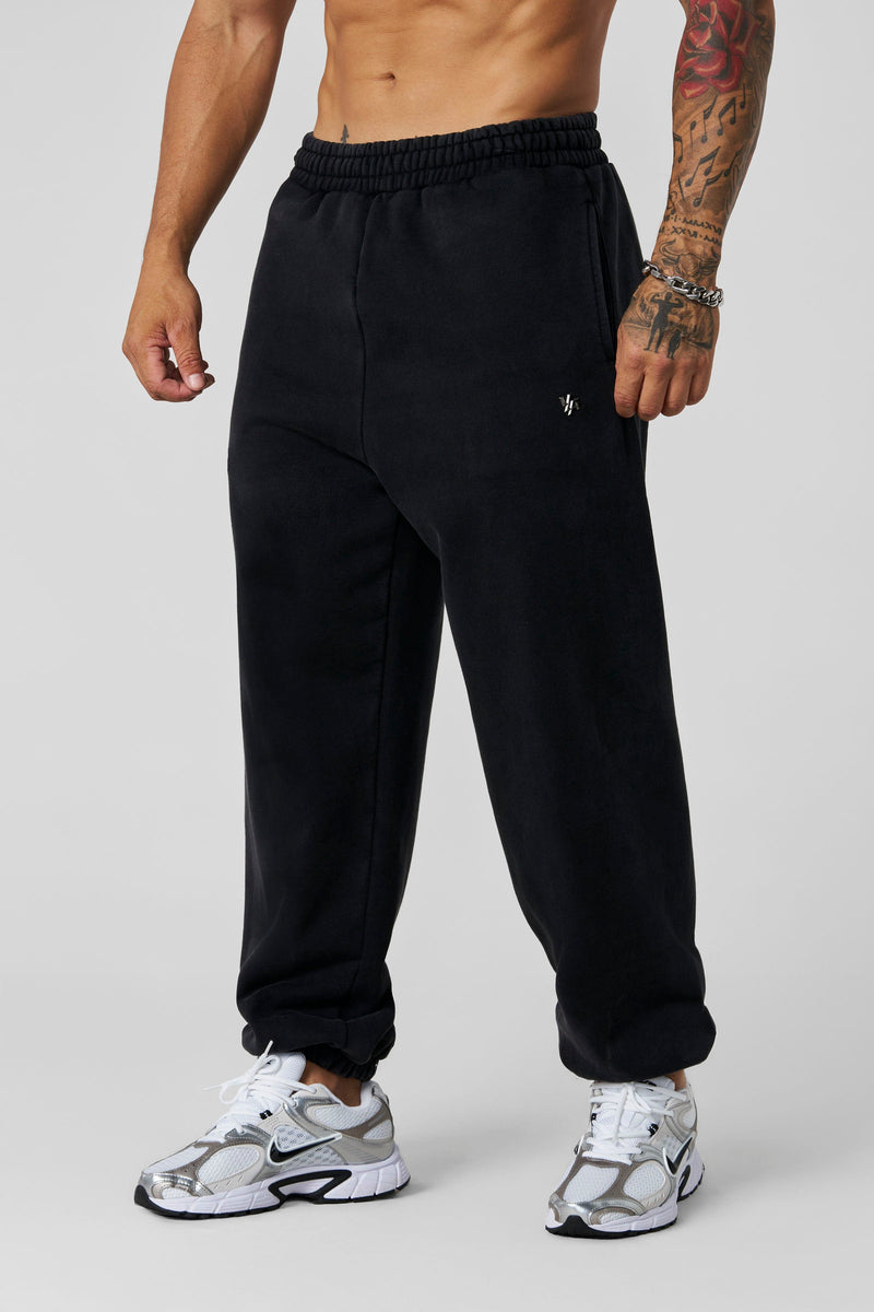 2069 - Elevated Essentials - Baggy Joggers — oversized, comfortable fit with cuffed ankles, structured heavyweight cotton, and subtle “Elevated” branding for a premium, versatile look in Black Wash