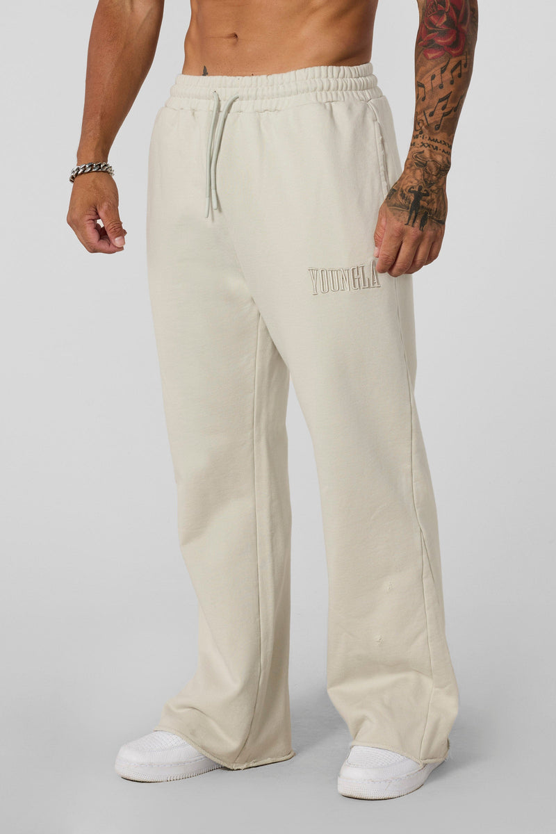 2077 - Flare Sweats - Heavyweight fleece sweats with structure and warmth. Minimal branding and clean lines create a bold, everyday-ready silhouette in Bone Wash.