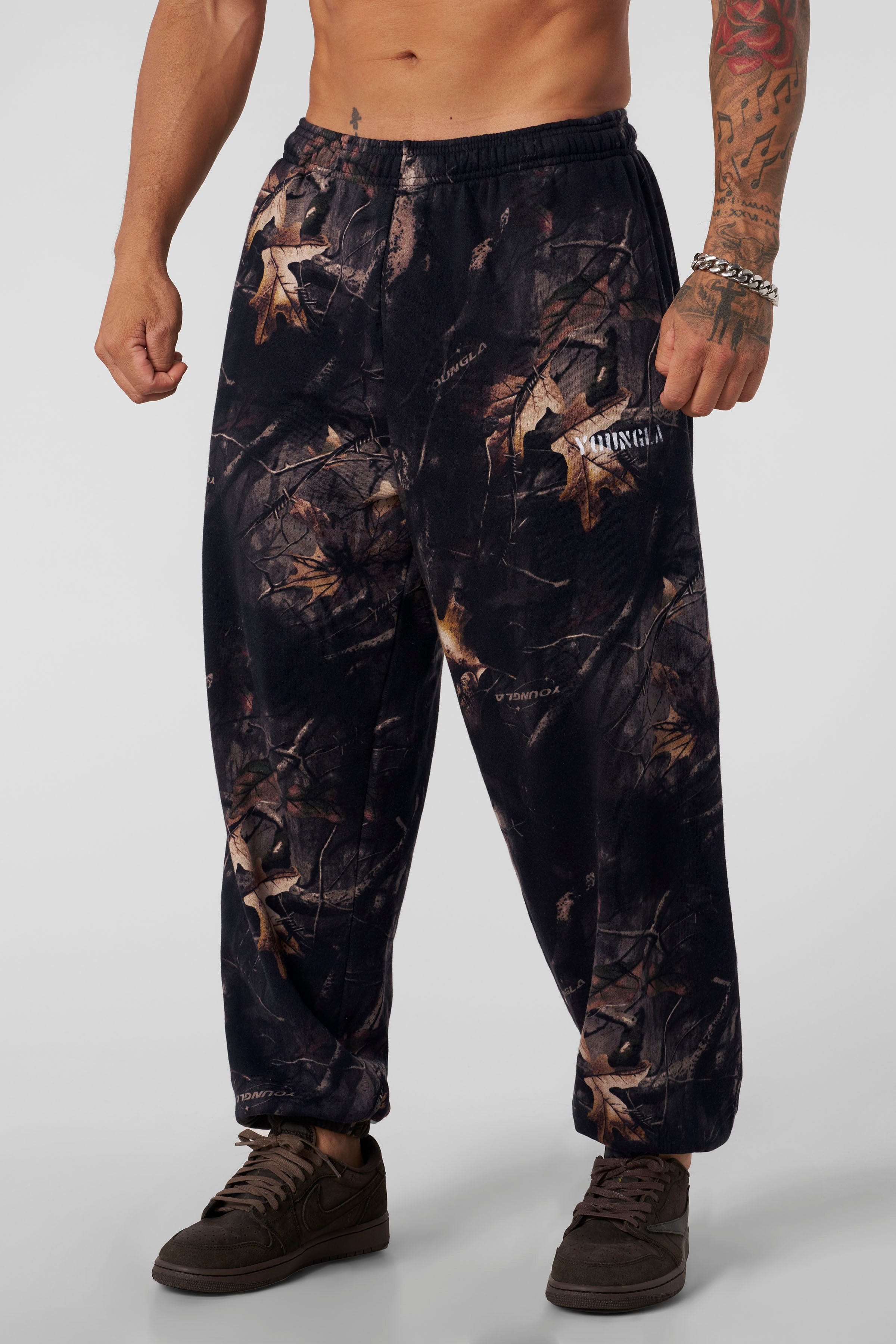 2063 Tree Camo Baggy Joggers — oversized, street-ready comfort with elastic cuffs, durable heavyweight terry, and a relaxed camo fit for everyday wear, in Black.