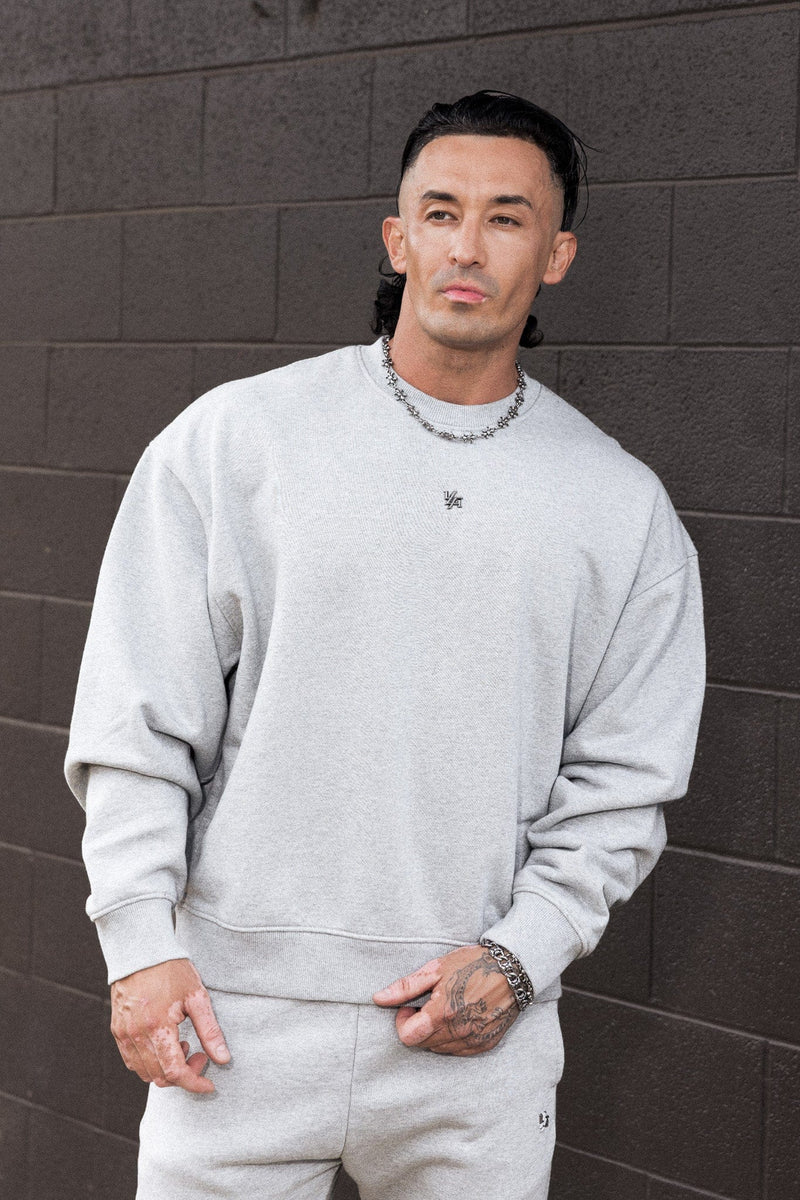 5095 - Elevated Essentials - Crewneck - Heavyweight cotton crewneck with a relaxed fit and ribbed cuffs. Soft interior and minimal 'Elevated' branding for a comfortable, premium everyday essential in Heather Grey.