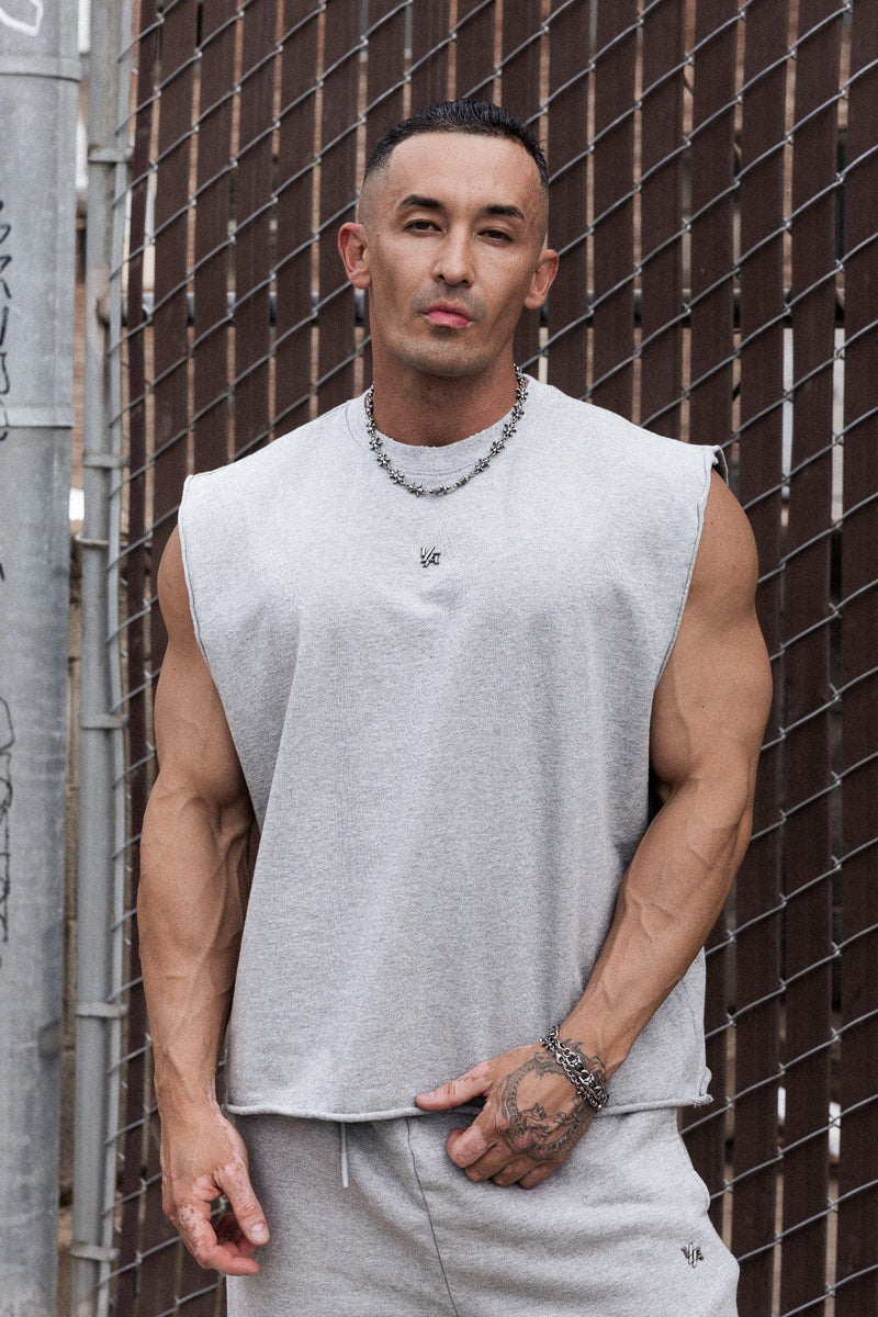 3035 - Elevated Essentials - Cut Offs - Relaxed fleece cut offs with raw-edge hems, lightweight premium cotton, small 'Elevated' logo in colour Heather Grey.