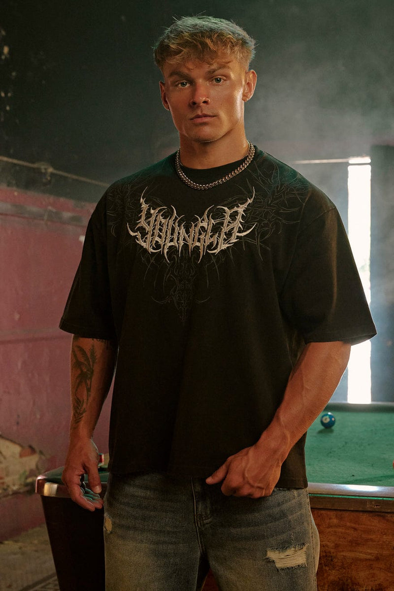 4149 - Gothic Tees- Oversized tee with bold gothic-inspired graphics on the back, structured yet comfortable, offering a sharp, wearable edge and statement-making style in Brown Wash