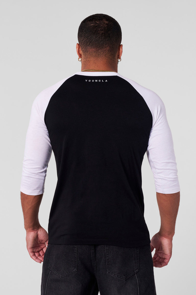 8072 - Superman 3/4 Raglan Shirts - Superman 3/4 Raglan Shirt – Lightweight 150 GSM fabric, soft & breathable, modern fitted cut. Features vintage Superman logo and contrast sleeves for a classic throwback style in Black/White.