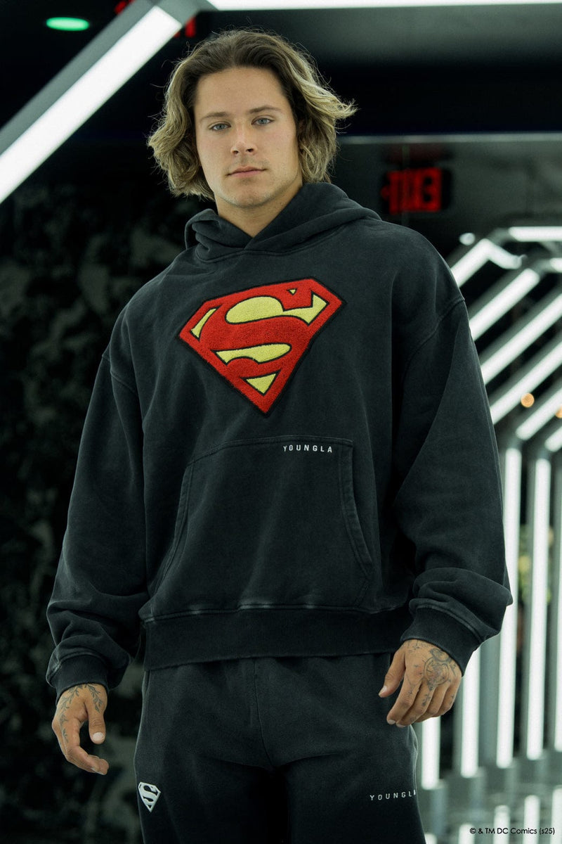 5079 - Superman Legacy Hoodies- Superman Legacy Hoodie in 460 GSM soft cotton with relaxed fit, featuring a chenille Superman logo patch on the chest and a clean acid-washed finish in Black Wash
