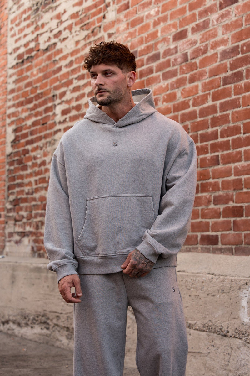 5096 - Elevated Essentials - Pullover Hoodies - Heavyweight cotton hoodie with a spacious fit, kangaroo pocket, and adjustable hood. Subtle 'Elevated' branding for a versatile, modern look in Heather Grey.