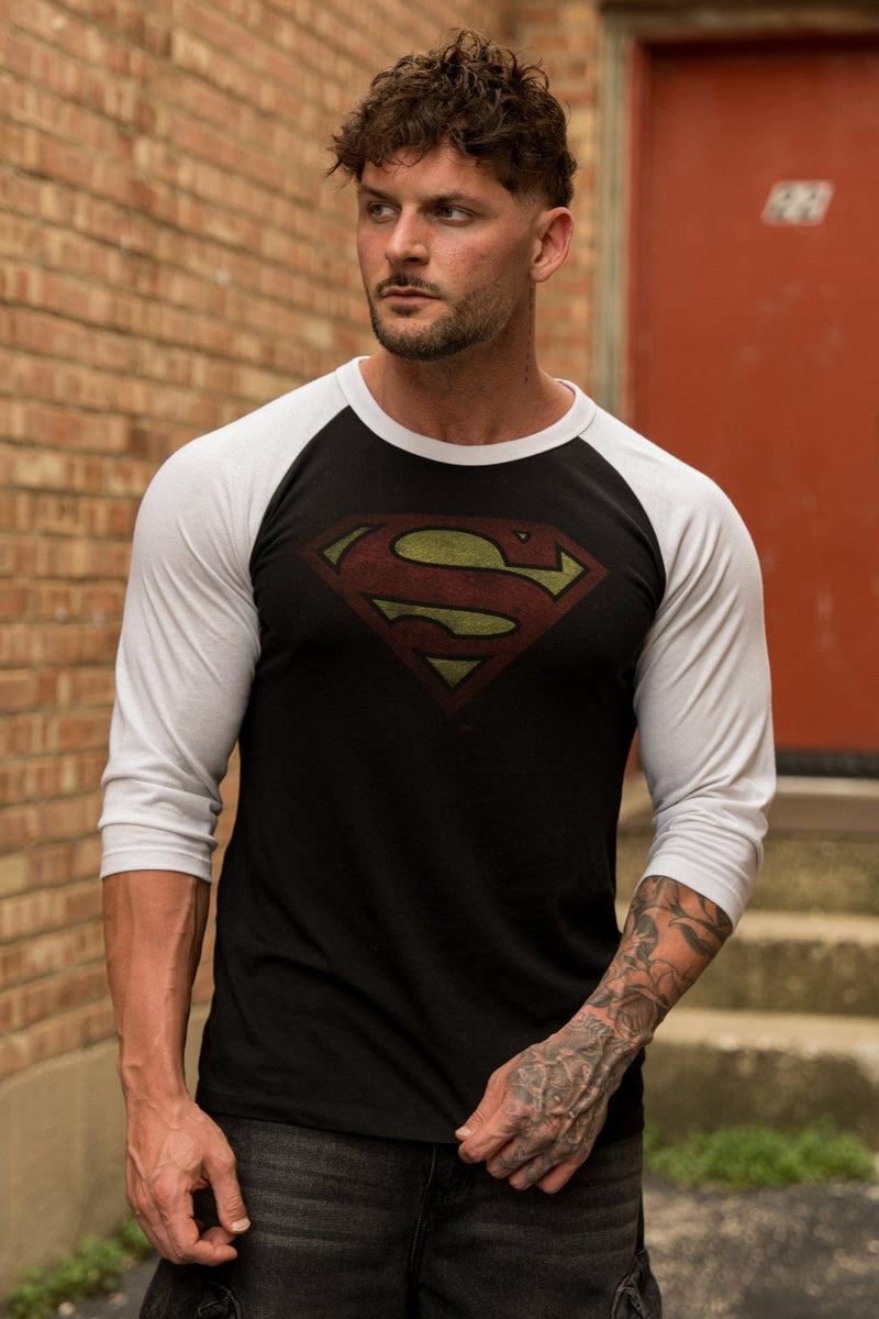 8072 - Superman 3/4 Raglan Shirts - Superman 3/4 Raglan Shirt – Lightweight 150 GSM fabric, soft & breathable, modern fitted cut. Features vintage Superman logo and contrast sleeves for a classic throwback style in Black/White.