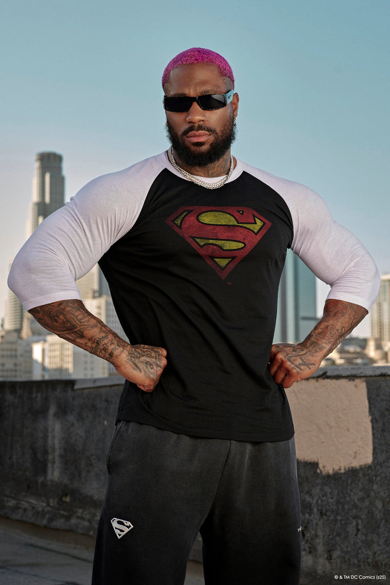 8072 - Superman 3/4 Raglan Shirts - Superman 3/4 Raglan Shirt – Lightweight 150 GSM fabric, soft & breathable, modern fitted cut. Features vintage Superman logo and contrast sleeves for a classic throwback style in Black/White.