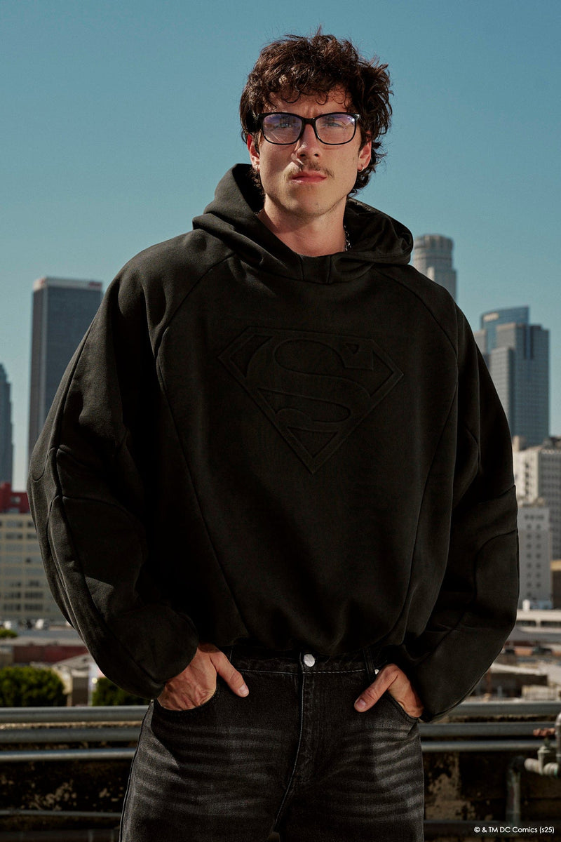 5094 - Superman Shield Hoodies - heavyweight 465 GSM cotton-poly blend with pieced panel cuts and a bold embossed Superman logo in Black Wash.