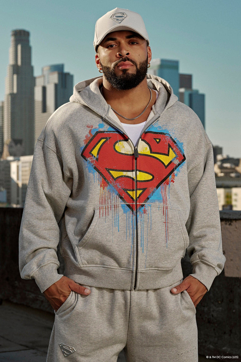 5011 - Superman Drip Zip-Ups - Hoodie iwith a bold paint-style Superman logo on the front, combining streetwear and superhero style in Heather Grey.
