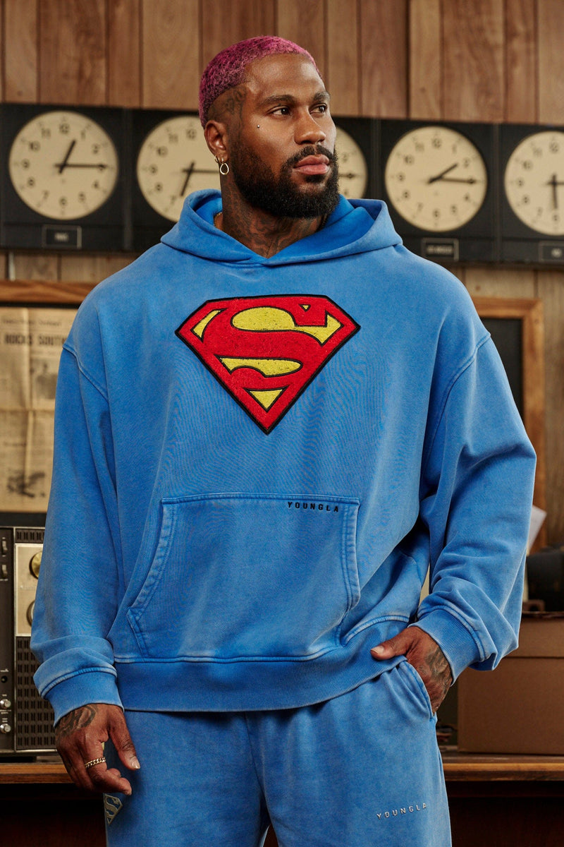 5079 - Superman Legacy Hoodies- Superman Legacy Hoodie in 460 GSM soft cotton with relaxed fit, featuring a chenille Superman logo patch on the chest and a clean acid-washed finish in Blue Wash