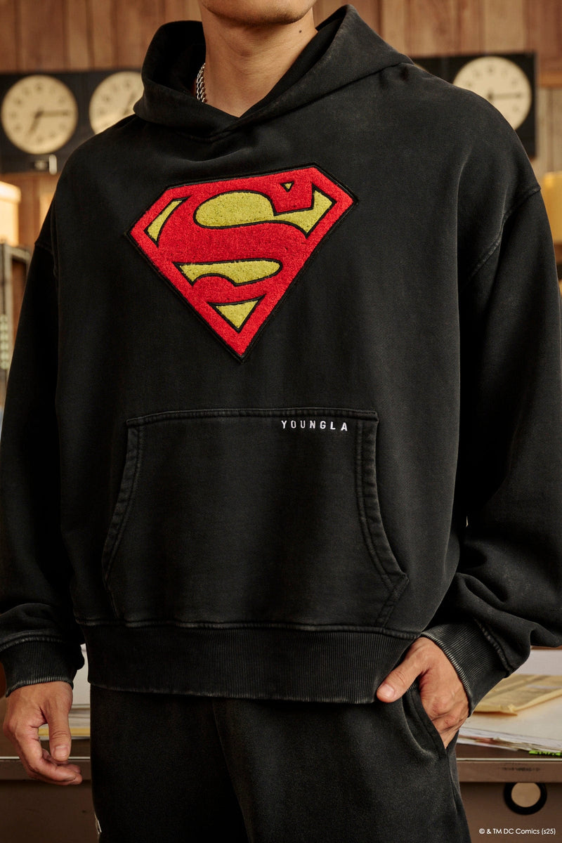 5079 - Superman Legacy Hoodies- Superman Legacy Hoodie in 460 GSM soft cotton with relaxed fit, featuring a chenille Superman logo patch on the chest and a clean acid-washed finish in Black Wash