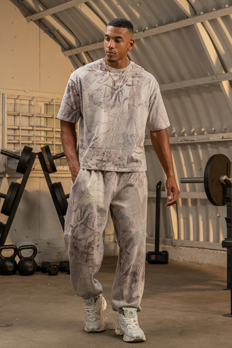2063 Tree Camo Baggy Joggers — oversized, street-ready comfort with elastic cuffs, durable heavyweight terry, and a relaxed camo fit for everyday wear, in Desert Tan.