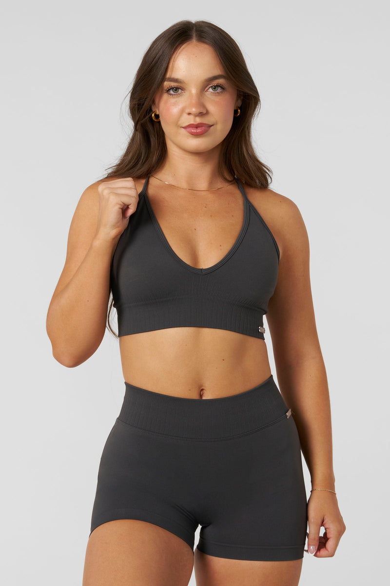 W367 - Sculpt Seamless Plunge Bra - Medium Impact Bra — ultra-soft seamless design with a flattering deep V-neckline and removable padding for adjustable support in colour Charcoal.