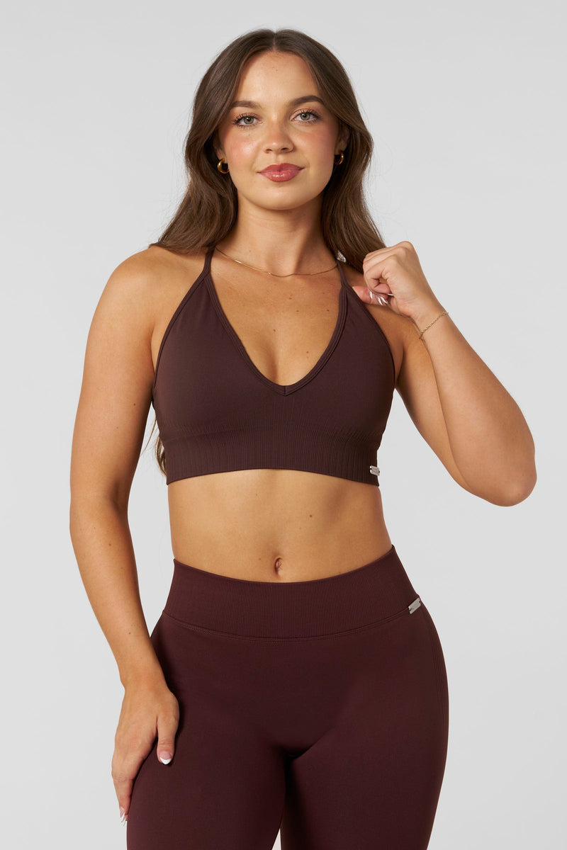 W367 - Sculpt Seamless Plunge Bra - Medium Impact Bra — ultra-soft seamless design with a flattering deep V-neckline and removable padding for adjustable support in colour Burgundy.