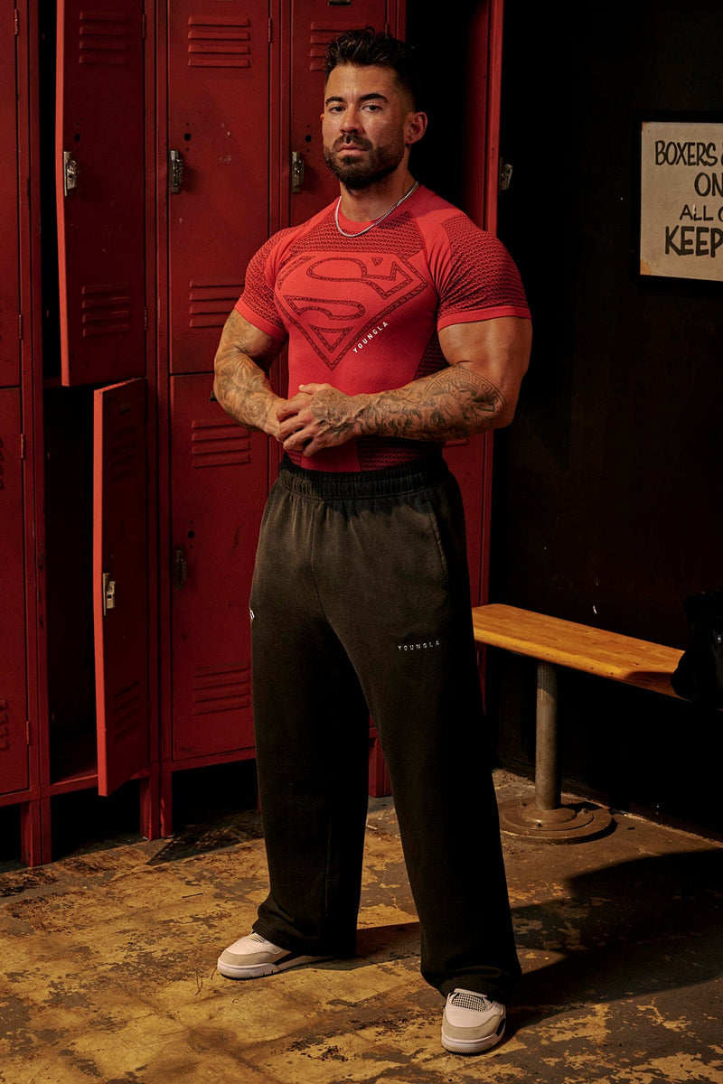 2032 - Superman Sweats - Man of Steel sweatpants from Superman x YoungLA collaboration, acid-wash design, YoungLA chrome logo on left leg, Superman logo on right, baggy fit for comfortable everyday wear in Red Wash